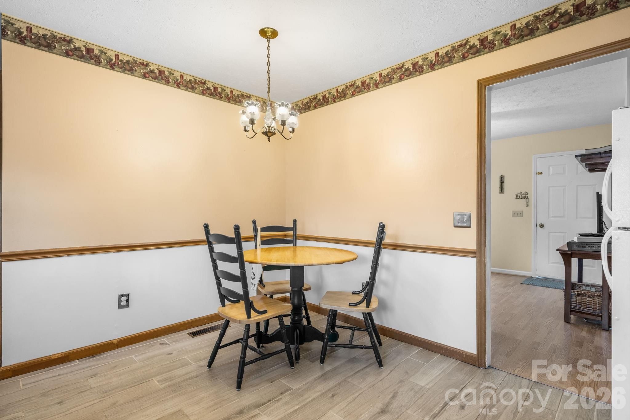 3384 Sheely Road Lenoir, NC 28645 - Photo 17 of 27 a view of a dining room with furniture and wooden floor