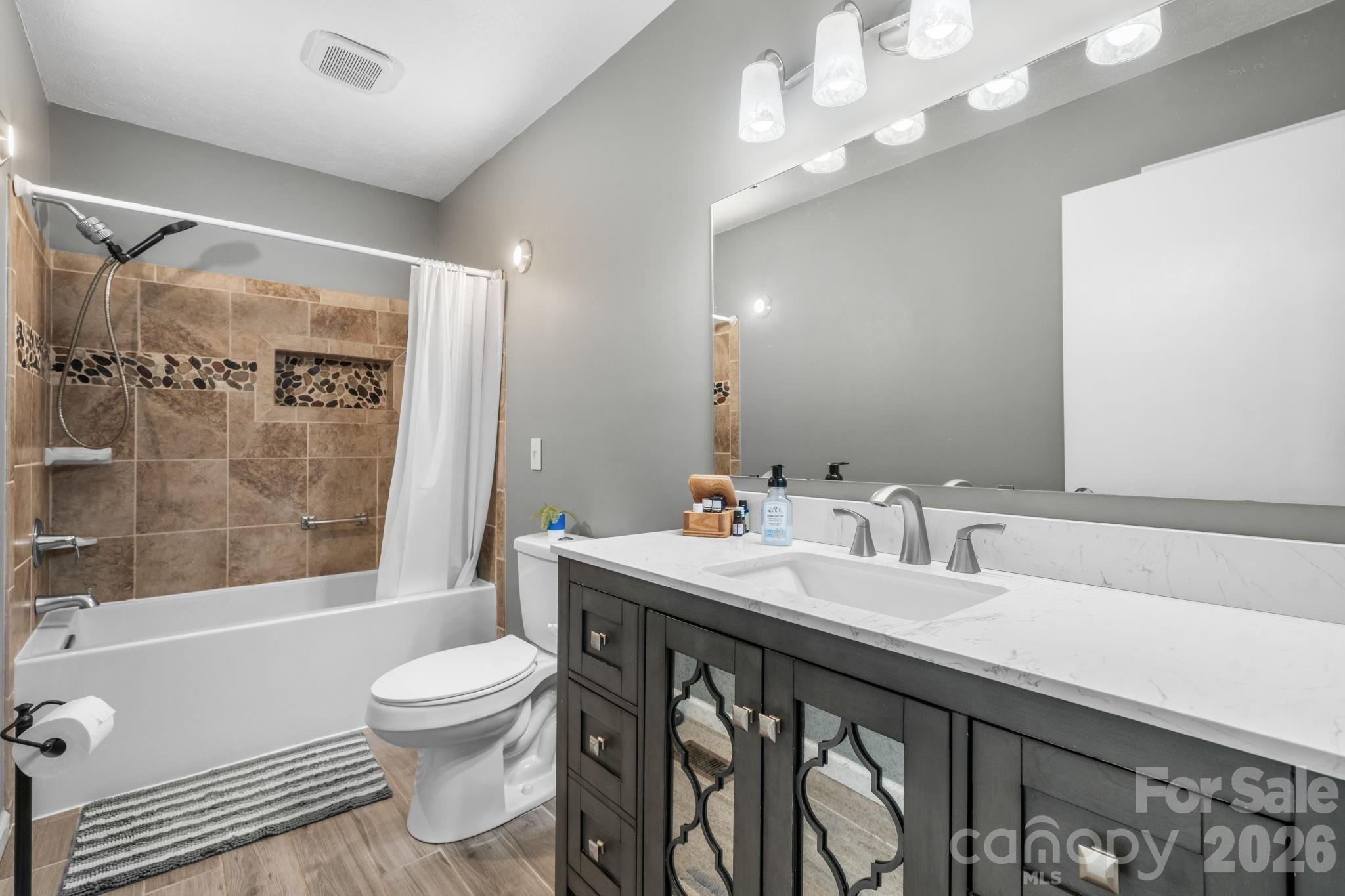 3384 Sheely Road Lenoir, NC 28645 - Photo 21 of 27 a bathroom with a sink a toilet and shower
