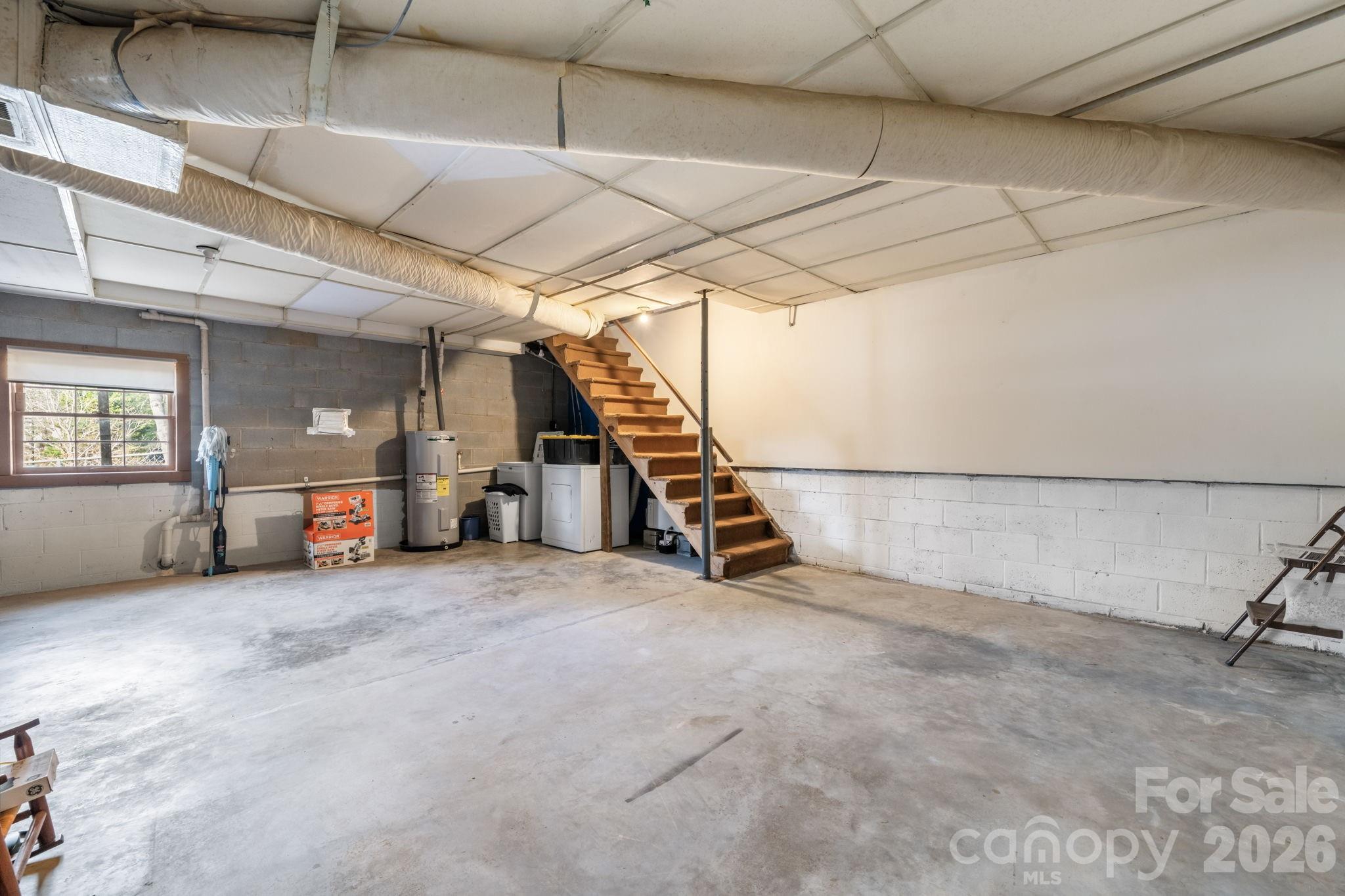 3384 Sheely Road Lenoir, NC 28645 - Photo 23 of 27 a view of an empty room with stairs and a ceiling fan