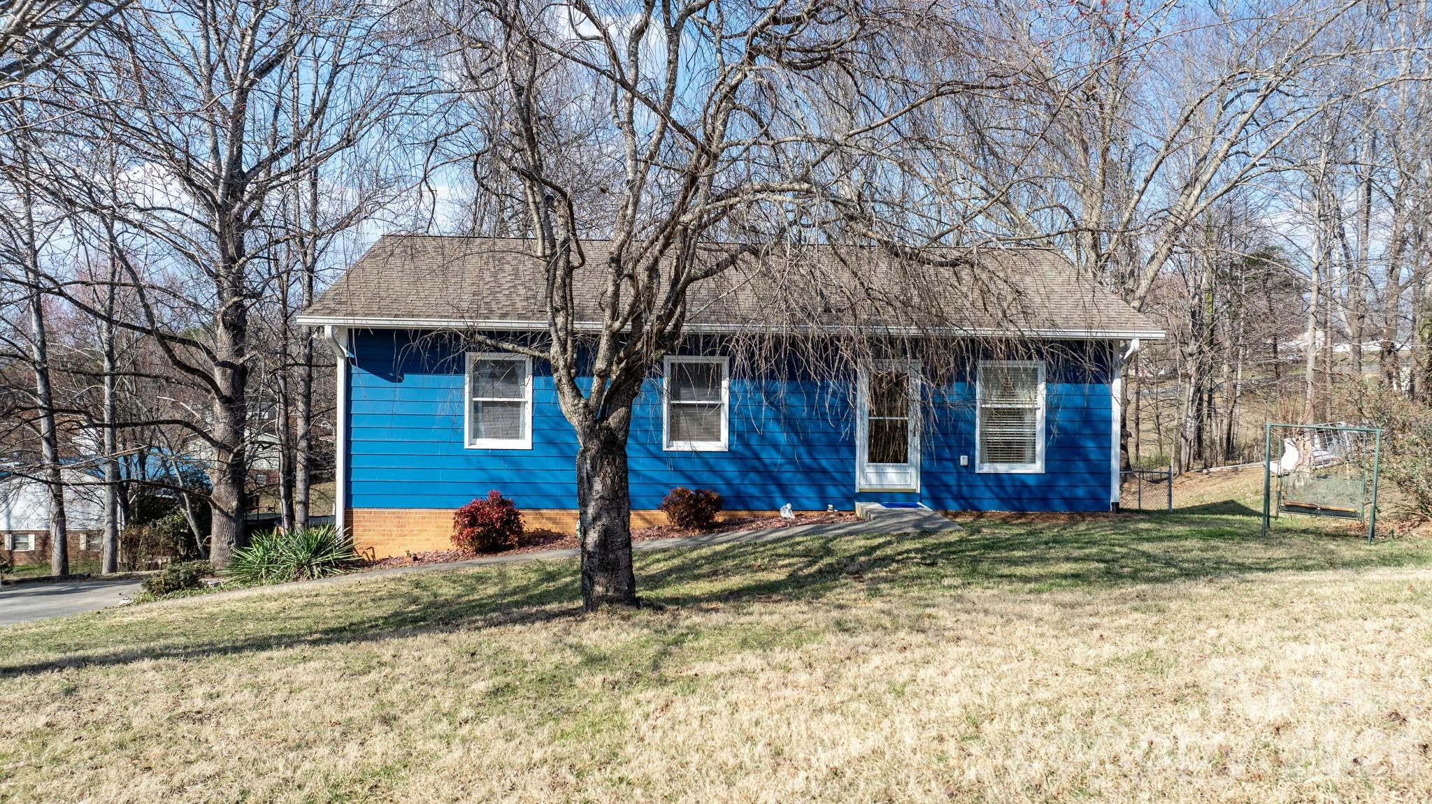 3384 Sheely Road Lenoir, NC 28645 - Photo 5 of 27 a view of a house with large trees and a large tree