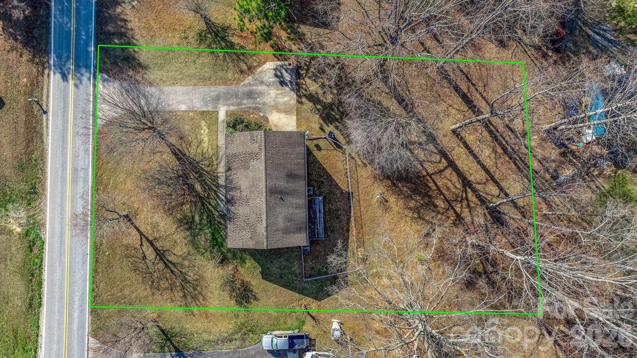 3384 Sheely Road Lenoir, NC 28645 - Photo 10 of 27 a backyard of a house with large trees