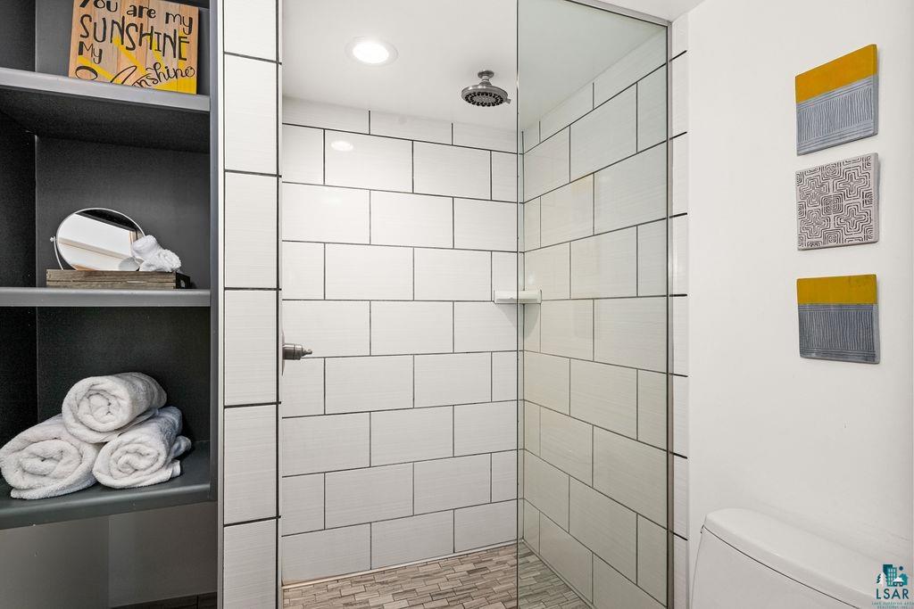 3206 Minnesota Avenue Duluth, MN 55802 - Photo 19 of 51 New Glass-enclosed shower with subway tile walls and a mosaic tile floor