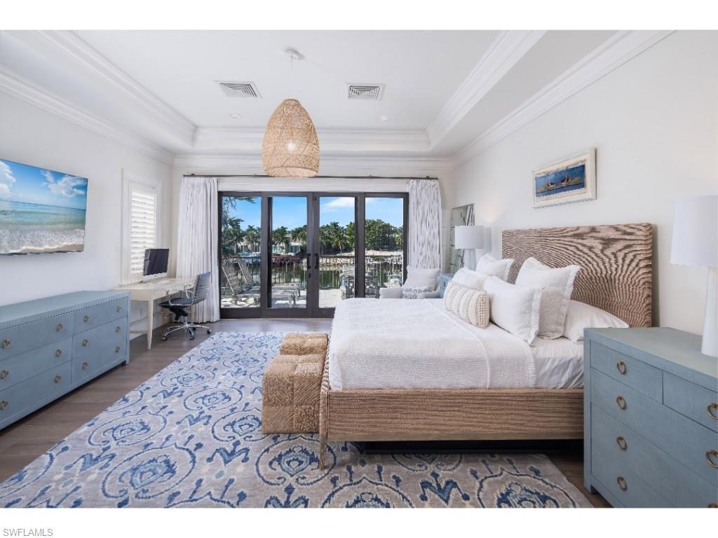 3430 Gin Lane Naples, FL 34102 - Photo 12 of 21 a bedroom with a large bed and a window