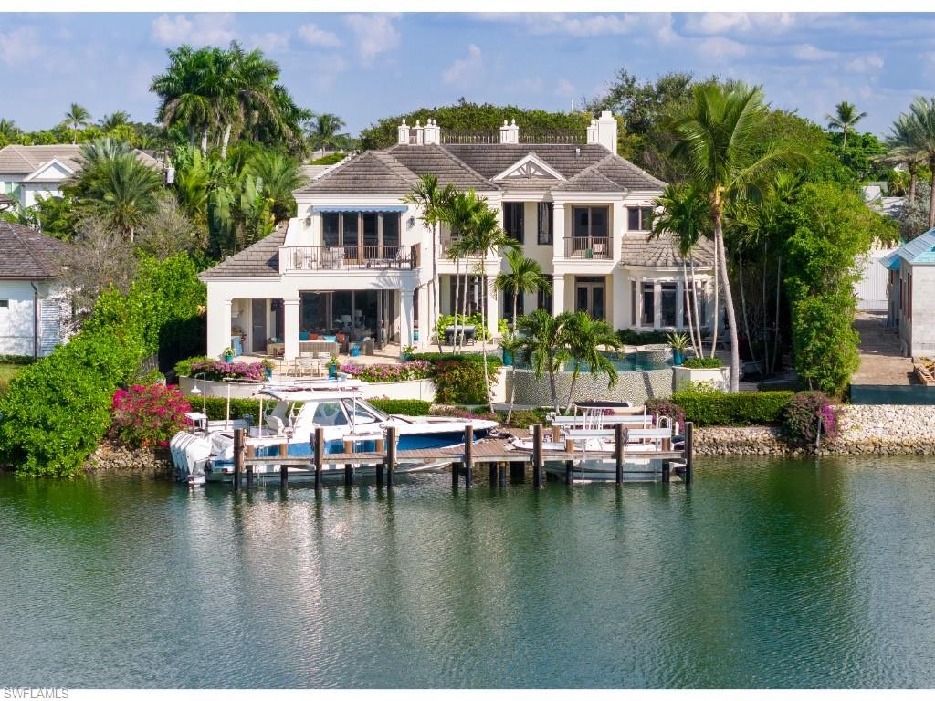 3430 Gin Lane Naples, FL 34102 - Photo 19 of 21 a view of a lake with a house swimming pool and outdoor space