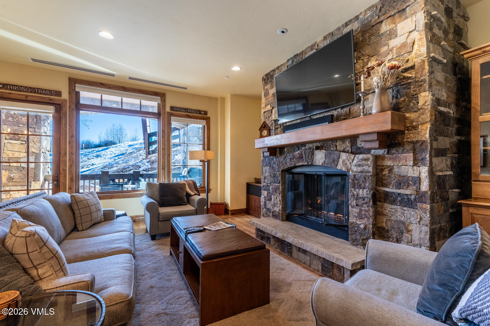 300 Prater Road, Unit B103 Avon, CO 81620 - Photo 3 of 17 a living room with furniture a flat screen tv and a fireplace
