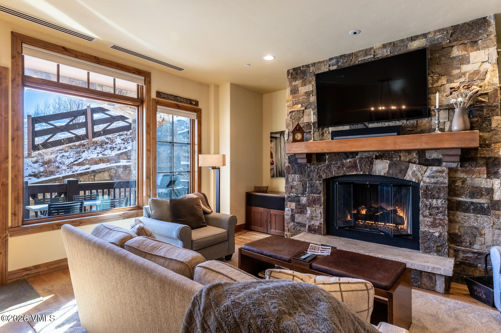 300 Prater Road, Unit B103 Avon, CO 81620 - Photo 5 of 17 a living room with furniture a flat screen tv and a fireplace