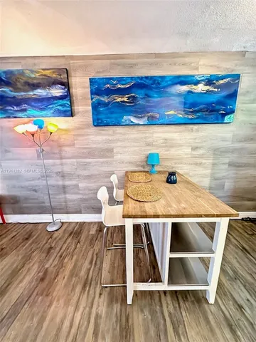 a view of a room with wooden floor and window