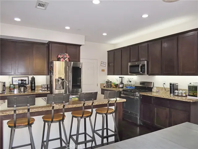 a kitchen with granite countertop a sink and cabinets