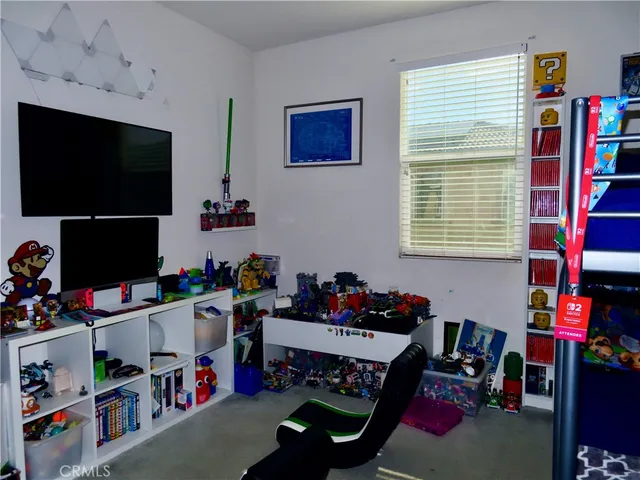 a living room with lots of furniture and baby toys