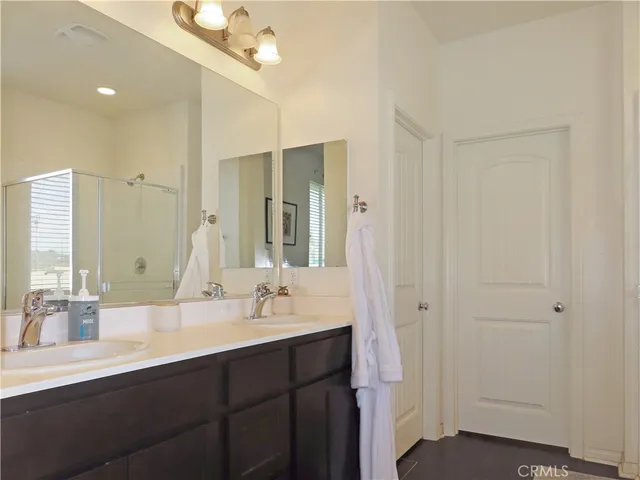 a bathroom with a double vanity sink mirror and double