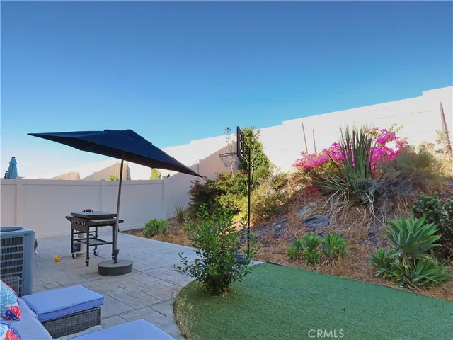 a view of a chairs and table in a backyard