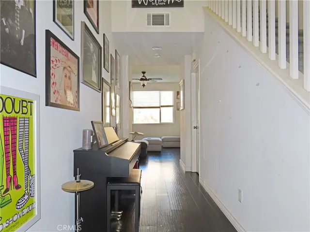 a view of a livingroom with furniture a ceiling fan and windows