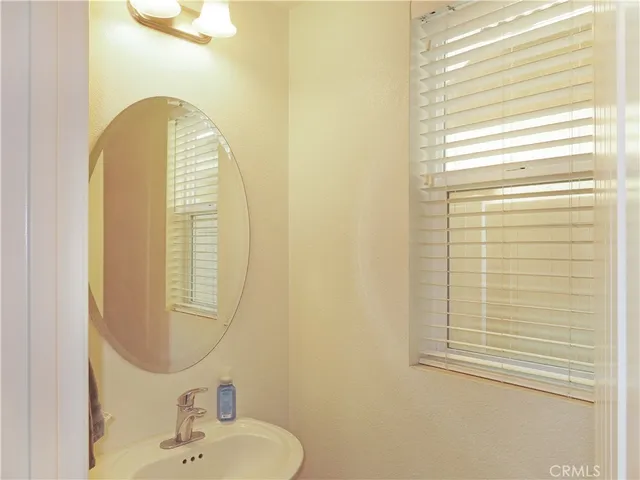 a bathroom with a sink a mirror and a shower