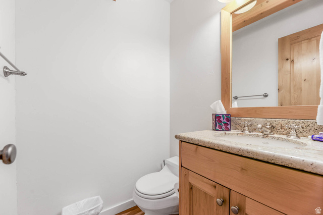 9927 Powder Run Road, Unit 10B Alta, UT 84092 - Photo 13 of 31 Bathroom with vanity and toilet in hallway near living room