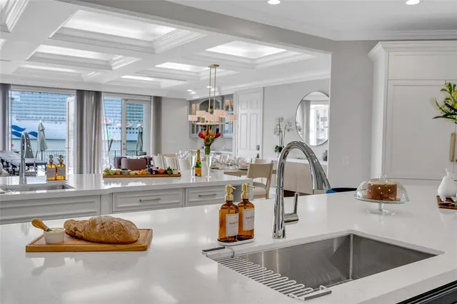 a kitchen with a sink and a cabinet with wooden floor