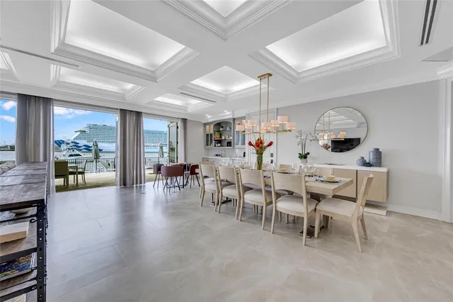a view of a dining room with furniture and chandelier