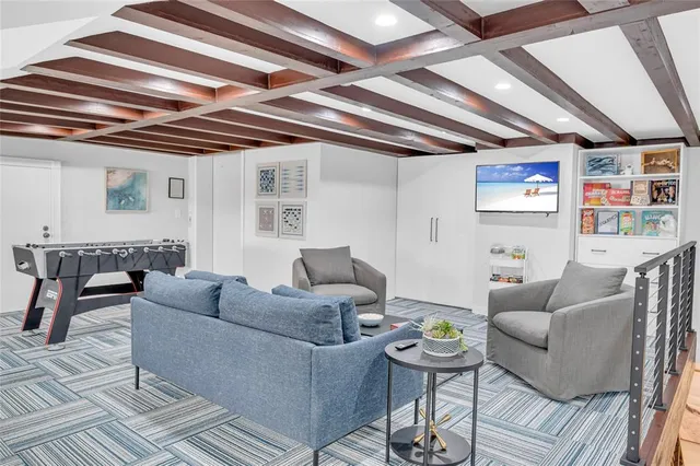 a living room with furniture and a chandelier