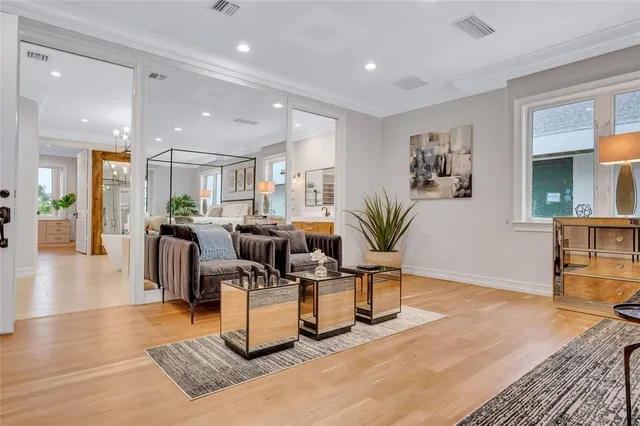 a living room with furniture hard wood floor and a table