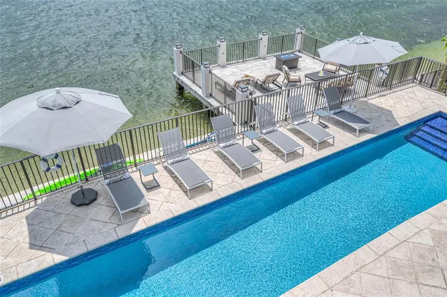 a spacious bedroom with a bed and glass windows