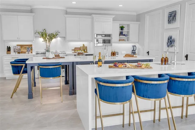 a kitchen with a stove a table and chairs in it