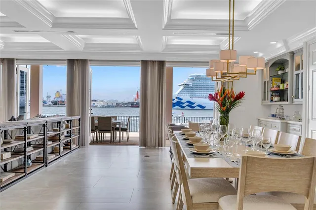 a dining room with furniture a chandelier and wooden floor