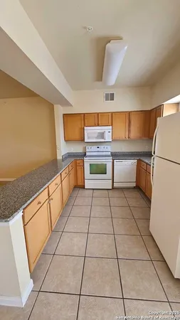 a kitchen with stainless steel appliances granite countertop a sink and a cabinets