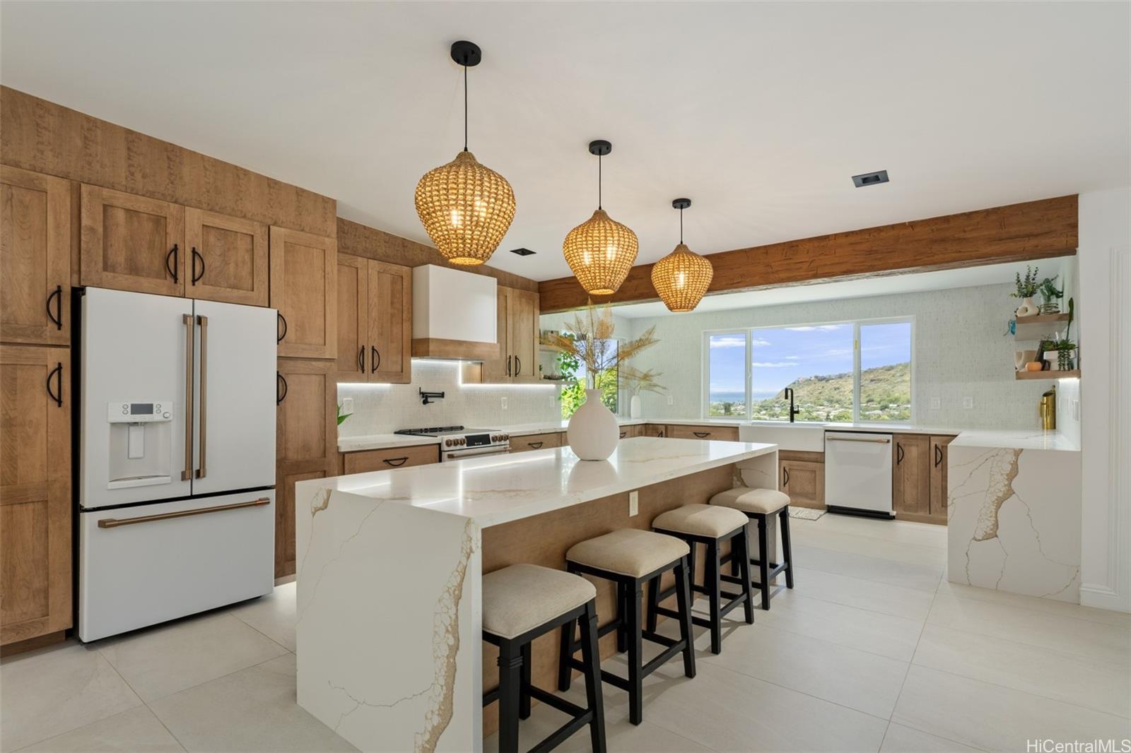 852 Kainoa Place Honolulu, HI 96821 - Photo 4 of 25 a very nice looking open kitchen with stainless steel appliances wooden floor and more cabinets