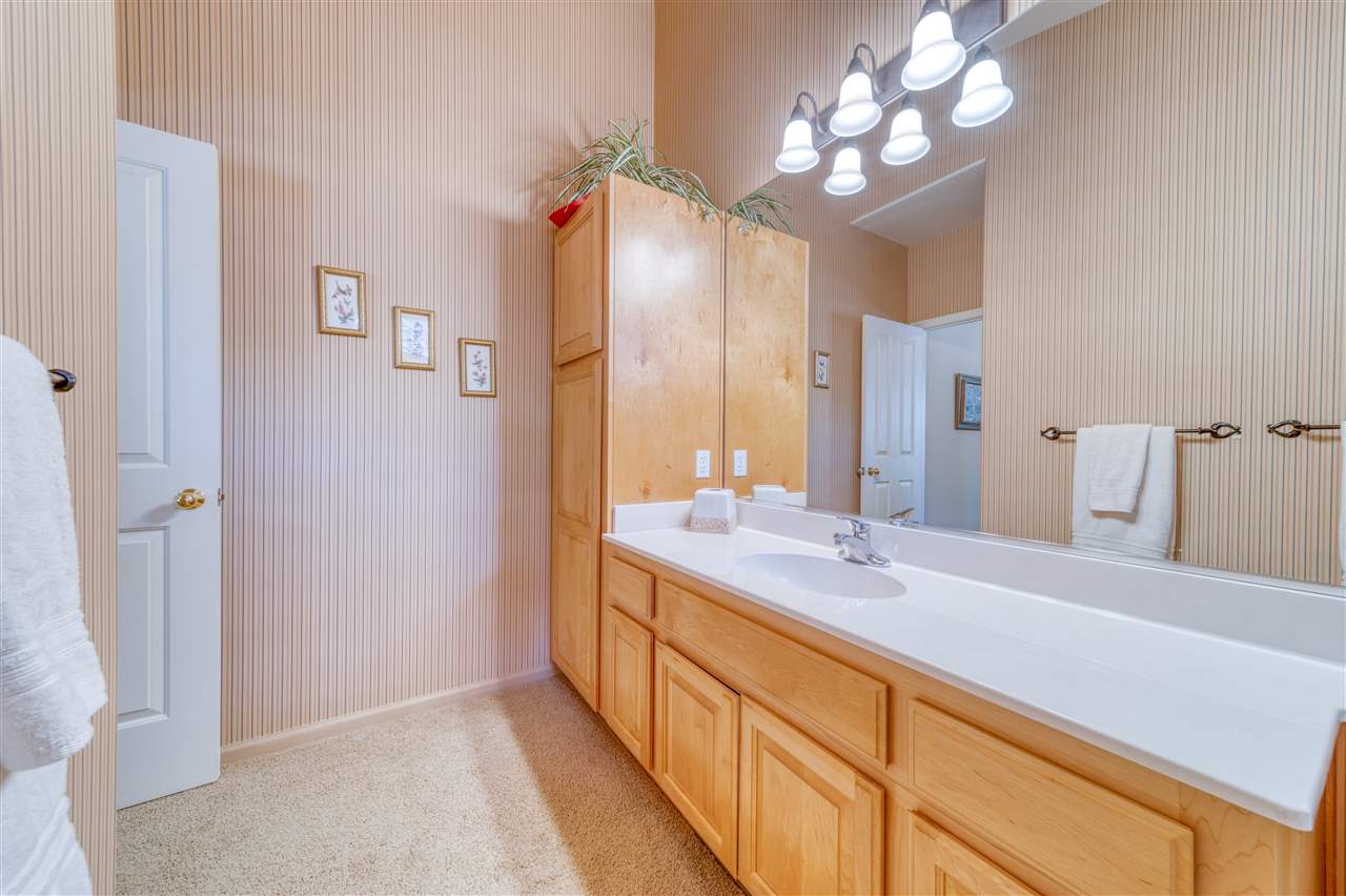 93 Bridle Path Clio, CA 96106 - Photo 13 of 21 a spacious bathroom with a double vanity sink and a mirror