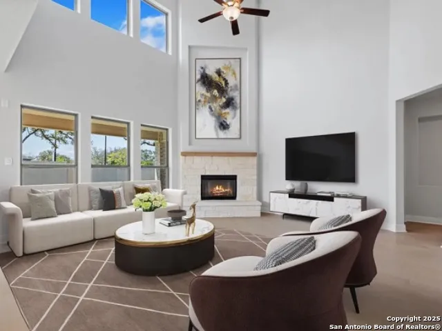 a living room with furniture a fireplace and a flat screen tv