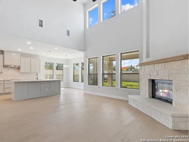 a living room with a fireplace and a floor to ceiling window