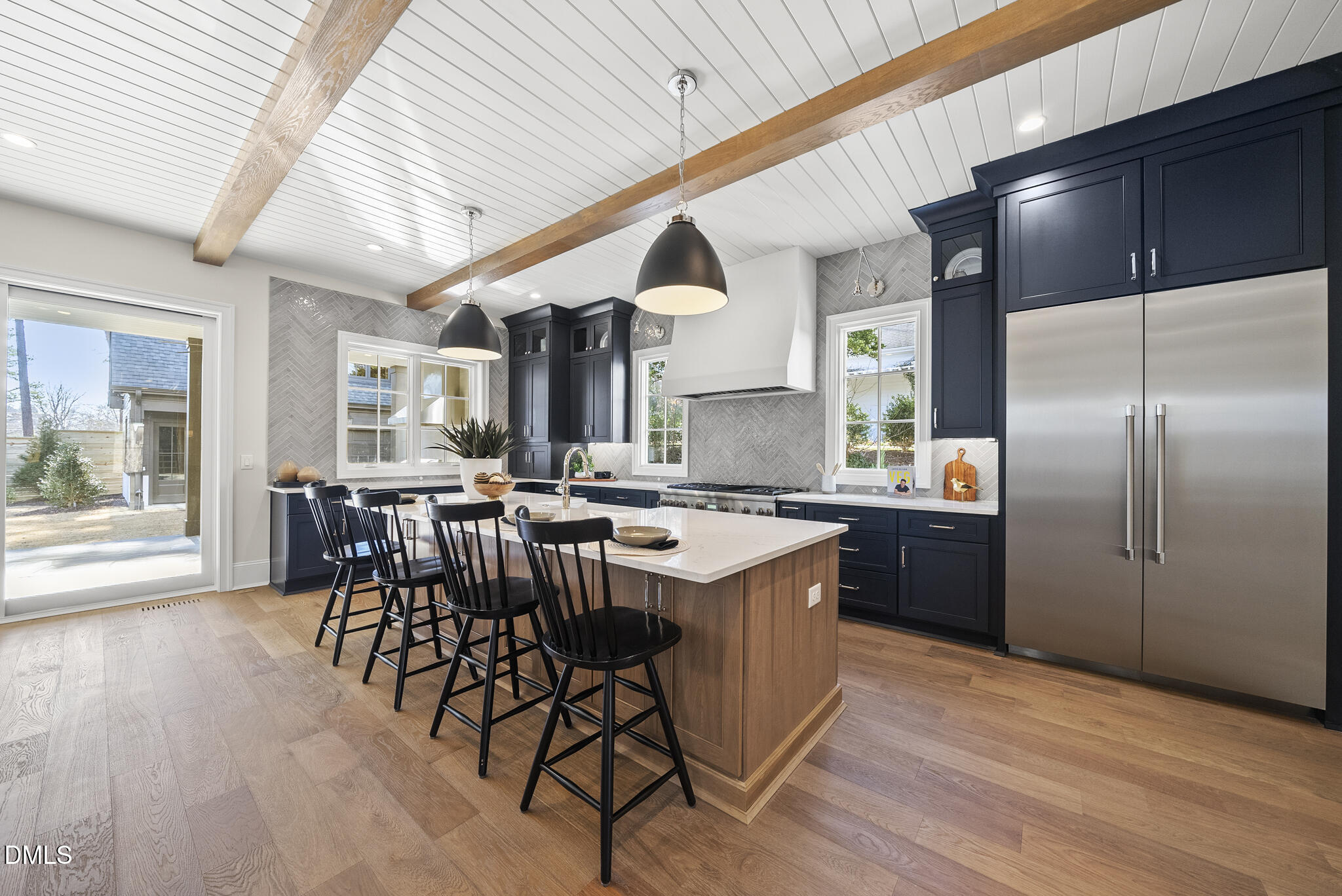3317 Hampton Road Raleigh, NC 27607 - Photo 7 of 45 a kitchen with stainless steel appliances granite countertop a table chairs and a wooden floor