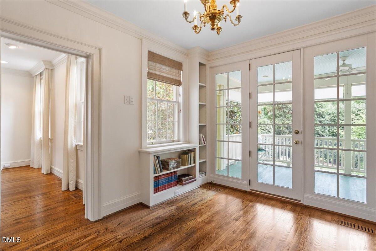 1128 Harvey Street Raleigh, NC 27608 - Photo 18 of 41 a view of an empty room with a window and wooden floor