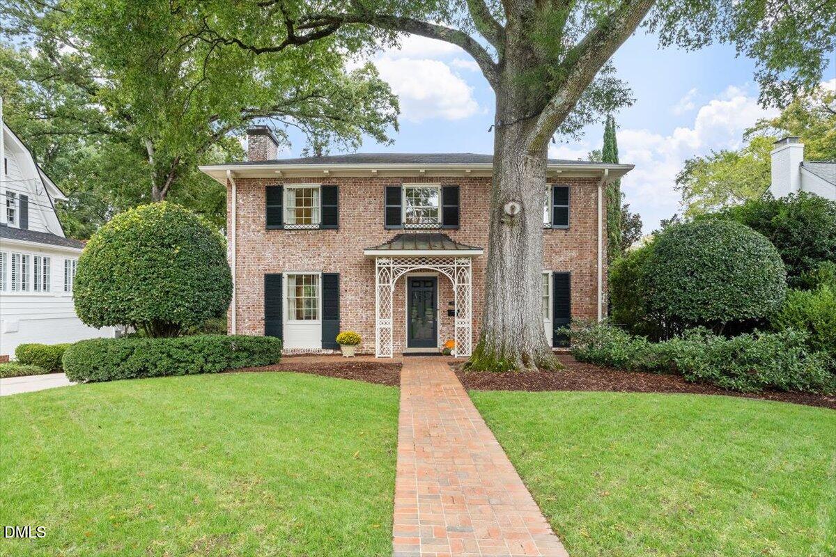 1128 Harvey Street Raleigh, NC 27608 - Photo 2 of 41 a front view of a house with a yard and trees