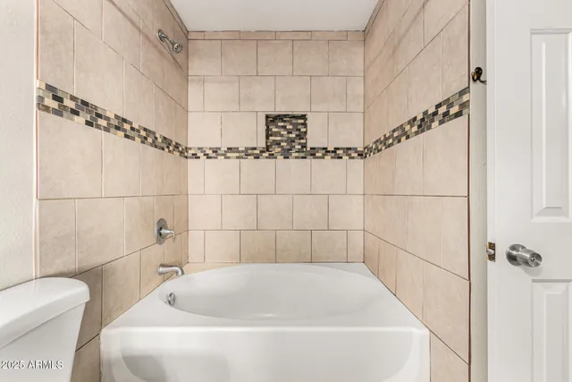 a bathroom with a white bath tub and a shower
