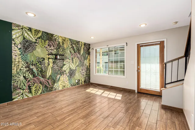 an empty room with wooden floor and a window