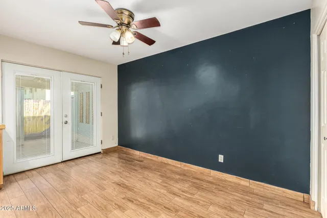 an empty room with fan and entrance