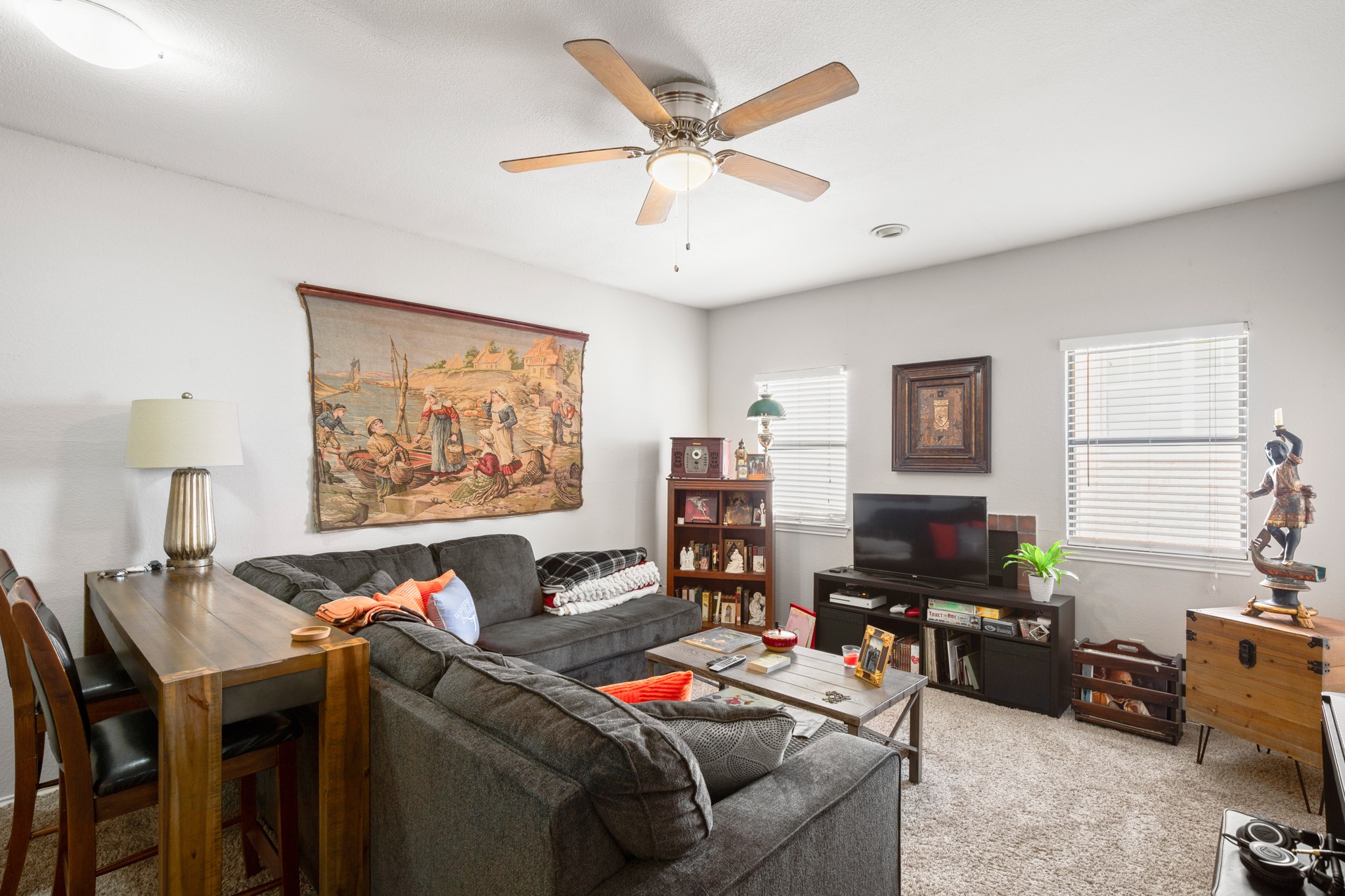 706 West 22nd Street, Unit 206 Austin, TX 78705 - Photo 2 of 18 Carpeted living area with a ceiling fan