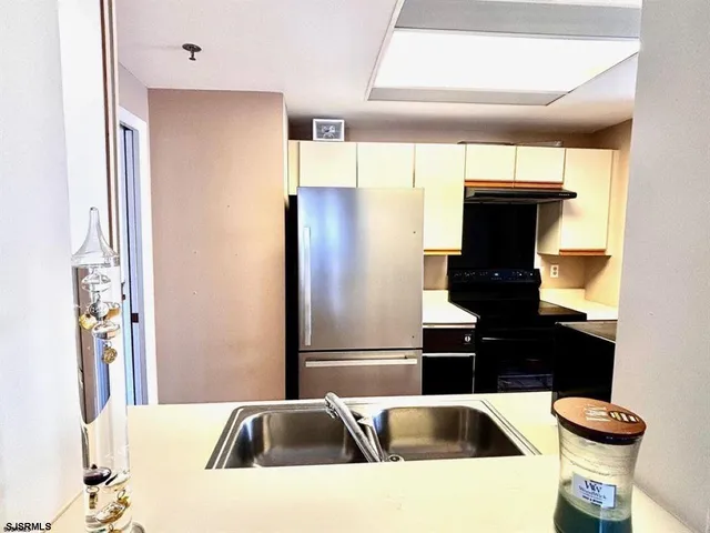 a kitchen with a refrigerator and a sink