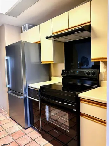 a kitchen with stainless steel appliances a stove and a refrigerator