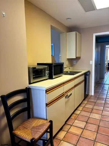 a kitchen with a sink cabinets and wooden floor