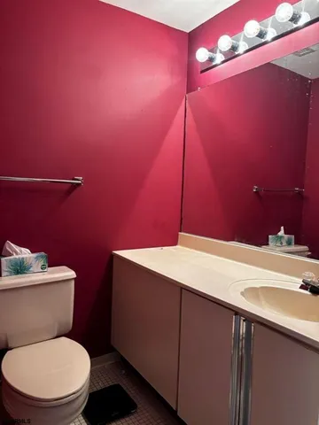 a bathroom with a sink a toilet and vanity