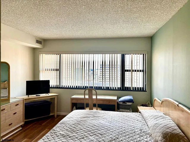 a bedroom with a bed and a television