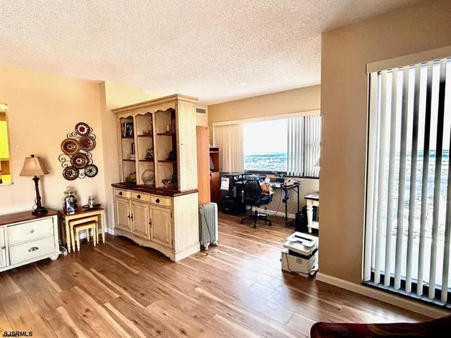 a living room with furniture window and wooden floor