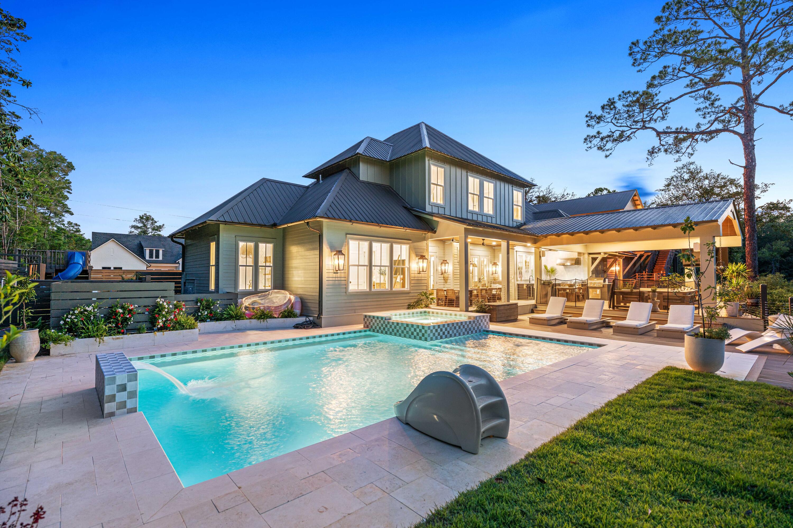 a view of a house with swimming pool and sitting area