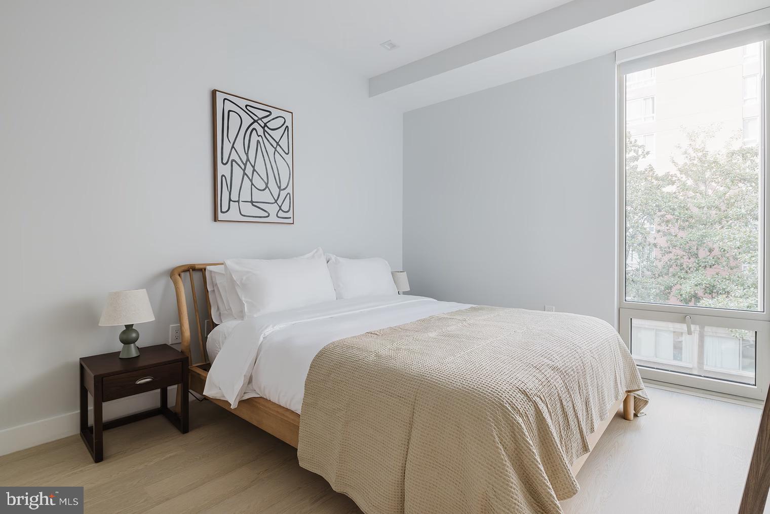 1224 M Street Northwest, Unit 502 Washington, DC 20005 - Photo 3 of 4 a bedroom with a bed and a large window