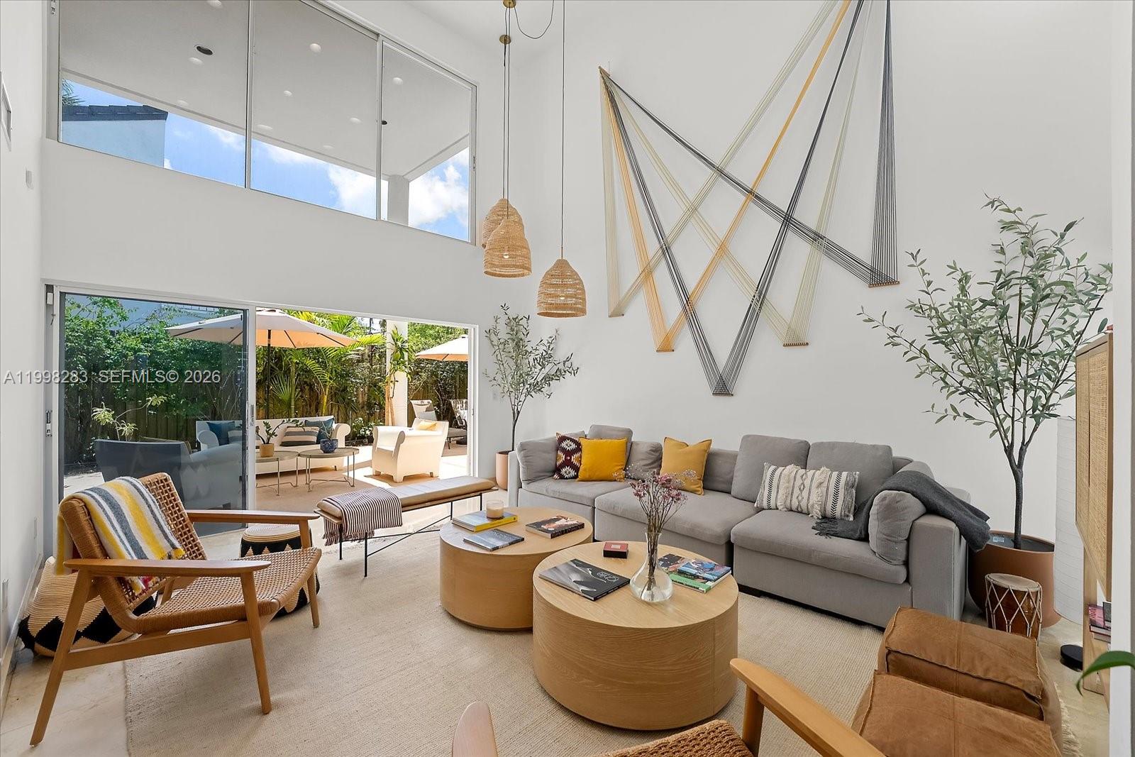 a living room with furniture a window and a table