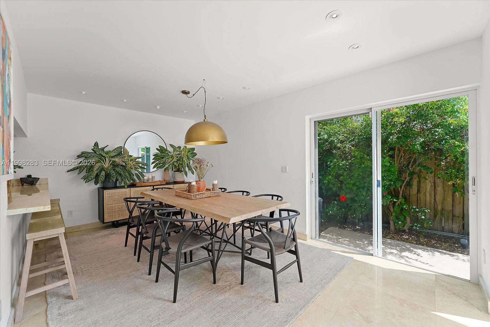 2721 Southwest 22nd Avenue, Unit A Miami, FL 33133 - Photo 11 of 36 a view of a dining room with furniture window and outside view
