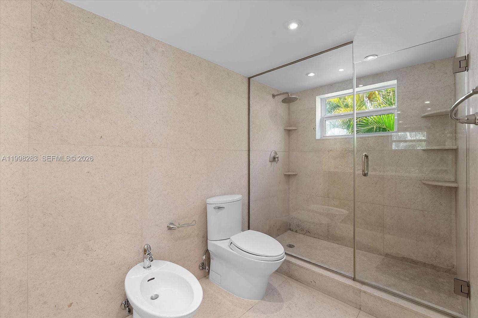 2721 Southwest 22nd Avenue, Unit A Miami, FL 33133 - Photo 28 of 36 a bathroom with a toilet and a shower