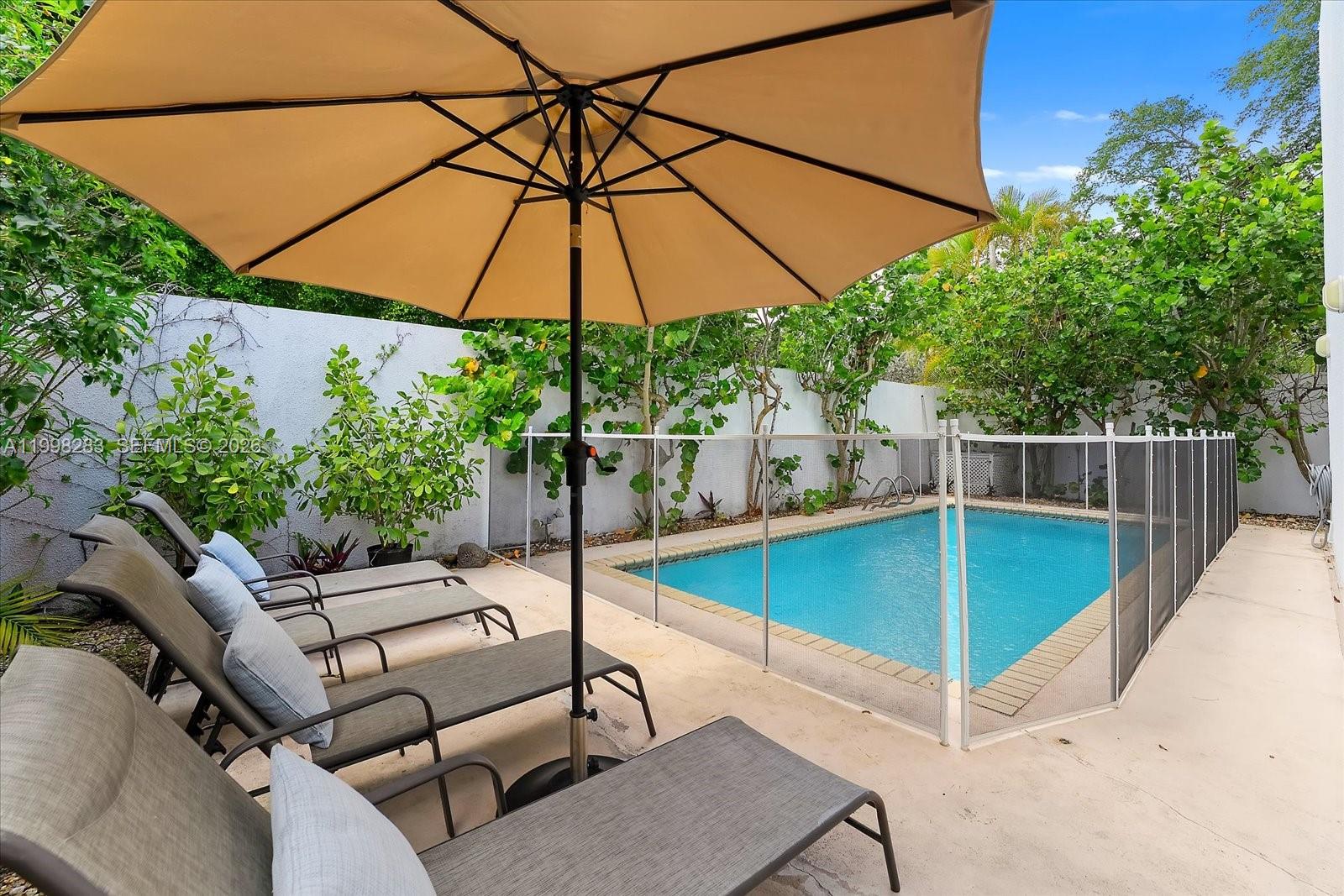 2721 Southwest 22nd Avenue, Unit A Miami, FL 33133 - Photo 5 of 36 a view of a backyard with swimming pool and furniture