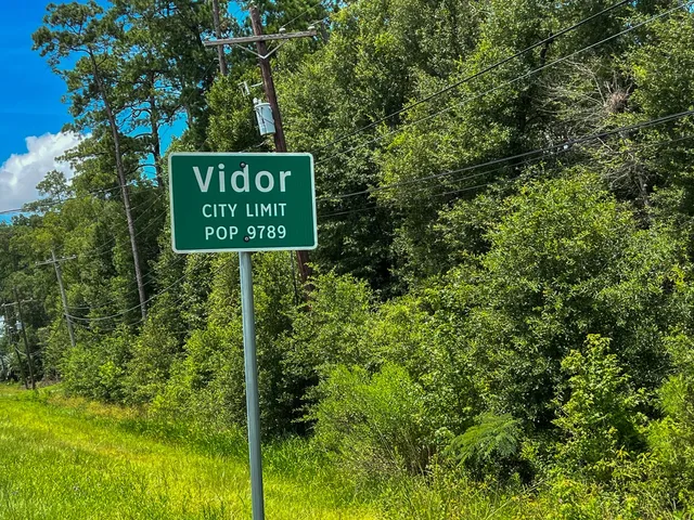 a sign broad in front of the green space